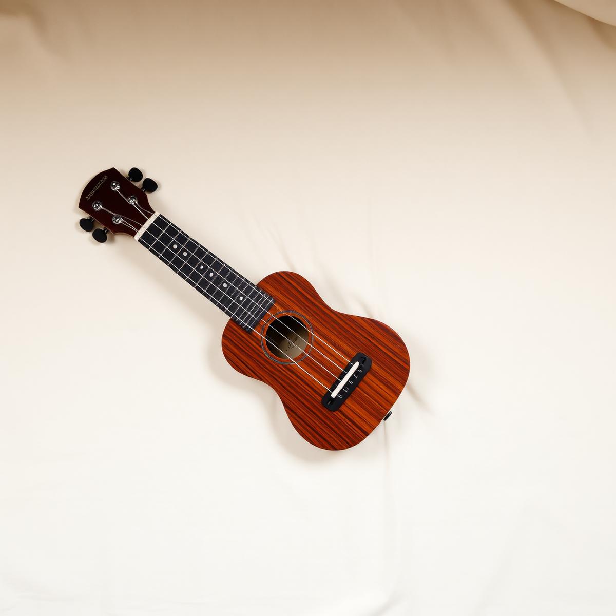 A beautiful soprano ukulele on cream linen